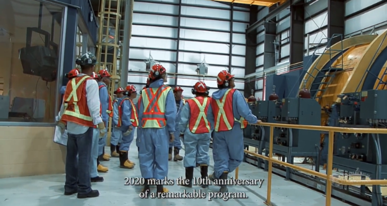 screenshot of video showing people touring an underground mine